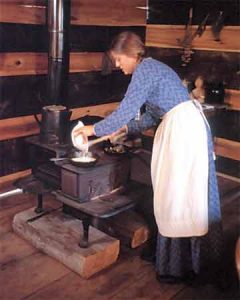 Breadmaking Making cornbread in an iron skillet on a wood stove.