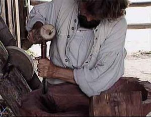 Carpenter or woodworker Chiseling a bowl from walnut wood to be used for making bread.