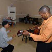 About the photo: The backstage photo shows Littleway in one of her other theatrical “roles,” conferring with musicians as director of a production of Robert John Trick the Devil at the St. Louis Black Repertory Company in spring 2003.